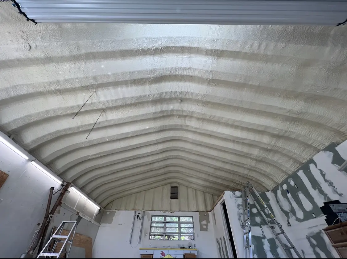 Spray polyurethane foam applied to the underside of a metal roof deck in Harrison
